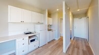 Located at 280 Dundas Street East in Toronto's vibrant downtown core, this compact studio unit offers an efficiently designed single-floor layout. Light-toned laminate flooring flows throughout, unifying the space and enhancing its bright, clean aesthetic.

The kitchenette is well-appointed with white shaker-style cabinetry extending to the ceiling for ample storage, a full-size refrigerator, a microwave, and a stainless steel sink — providing all essential cooking and dining amenities in a thoughtfully organized footprint.

An open living area connects seamlessly to the rest of the unit, featuring a large window that frames views of the surrounding Toronto cityscape and allows generous natural light to fill the room. A built-in desk shelf beneath the window offers a practical workspace, while a baseboard heating unit ensures year-round comfort.

A hallway leads to a sliding-door closet, offering dedicated wardrobe storage, alongside a private bathroom equipped with a shower-tub combination. The unit's neutral grey and white color palette throughout contributes to a clean, modern feel. Recessed lighting and crisp white trim complete the polished interior finish, making this a functional and well-considered urban living space.