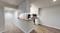 Located at 500 Harbor Pointe Pkwy in Sandy Springs, GA, this single-floor, 2-bedroom, 3-bathroom residence offers a practical and comfortable layout. The combined kitchen and living area serves as the heart of the home. The galley-style kitchen is well-equipped with white cabinetry, granite-look countertops, stainless steel refrigerator, electric range, and a dishwasher, all set atop wood-look flooring. A peninsula counter connects the kitchen to the open living area, which features a ceiling fan with light fixture and direct access to the outdoors through French-style patio doors.

Both bedrooms are carpeted and finished with neutral tones, offering a cozy atmosphere. The primary bedroom includes mirrored sliding closet doors that enhance the sense of space, while the second bedroom benefits from natural light through a window. Ceiling fans are present in the bedrooms for added comfort.

The three bathrooms each feature white tiled tub-and-shower combinations with clean, simple finishes and wood-look flooring. Two hallways connect the rooms efficiently throughout the layout. Textured ceilings are consistent throughout the home, contributing to its classic residential character. The overall aesthetic is clean, neutral, and move-in ready.
