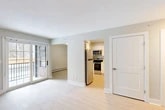 Located at 9 Sullivan St in Cazenovia, NY, this single-floor, one-bedroom, one-bathroom unit offers a well-organized layout across a compact yet functional footprint. Light hardwood flooring runs throughout, complementing the neutral, soft-gray wall tones that lend a clean and airy feel to every room.

The open living and dining area is bright and inviting, anchored by sliding glass doors that provide outdoor access and fill the space with natural light. Baseboard heating is present throughout, ensuring year-round comfort. The kitchen is thoughtfully appointed with white shaker-style cabinetry, marble-look quartz countertops, a stainless steel sink, and a full suite of stainless steel appliances including a refrigerator, electric range, microwave, and dishwasher.

The bedroom is a comfortable, well-proportioned room featuring a window with natural light, a closet with sliding doors, and track lighting. The bathroom is clean and functional, offering a full tub-shower combination with tiled surround, a toilet, and a vanity. An additional closet provides supplementary storage. The unit's cohesive design, modern finishes, and efficient use of space make it a practical and attractive residence in the heart of Cazenovia.