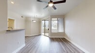 Located in Glendale, Arizona, this single-story 2-bedroom, 2-bathroom residence offers a clean, modern aesthetic throughout. Wood-style plank flooring runs continuously across all living areas, lending warmth and visual cohesion to the space. The open living and dining area is bright and airy, illuminated by natural light from a sliding glass door that leads to a private balcony, offering outdoor views. A ceiling fan overhead and a stylish pendant light above the dining area add functional charm.

The kitchen features light wood cabinetry, ample counter space, stainless steel appliances including a gas range, microwave, dishwasher, and refrigerator, and a convenient pass-through counter that connects to the living area.

Both bedrooms are comfortably sized, each equipped with ceiling fans and large windows fitted with blinds that allow abundant natural light. The spacious primary bedroom includes a closet, while the second bedroom also offers generous proportions. Each bathroom is well-appointed with light wood vanity cabinetry, white countertops, a large mirror with overhead lighting, and a shower-tub combination with wood-style tile flooring. The layout connects the rooms through multiple hallways, providing a practical and efficient flow throughout the residence.