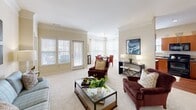 Located at 4800 Alexander Valley Dr in Charlotte, NC, this single-floor, 2-bedroom, 2-bathroom residence offers a comfortable and cohesive layout designed for everyday living. The combined living and dining area serves as the heart of the home, featuring plush carpeting, crown molding, and abundant natural light streaming through large windows and a glass door. The bay-windowed dining nook provides an intimate setting, while the open living space offers generous room for seating and entertaining. The kitchen is outfitted with warm wood cabinetry, dark granite-style countertops, black appliances, and hardwood flooring, creating a functional and stylish workspace. The primary bedroom is a well-sized retreat with soft carpeting and ample natural light, while the second bedroom offers a calm, cozy atmosphere with neutral tones and window access. The primary bathroom features both a soaking tub and a separate glass-enclosed shower, dual vanity sinks, and hardwood flooring. A second full bathroom includes a wide vanity with dual sinks and hardwood floors as well. A hallway with decorative touches, including a classic arched clock wall feature, connects the spaces seamlessly, contributing to the warm, welcoming character of this Charlotte home.
