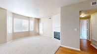 Located at 2801 Nelson Rd in Longmont, Colorado, this one-bedroom, one-bathroom residence offers a well-organized single-floor layout with a warm, neutral color palette throughout. The spacious living room is a standout feature, centered around a tile-surround fireplace with a classic white mantel, plush carpeting underfoot, and large windows with blinds that invite generous natural light. A sliding glass door provides direct access to the private balcony. The kitchen is outfitted with stainless steel appliances—including a refrigerator, range, microwave, and dishwasher—complemented by white cabinetry, granite-style countertops, and hardwood flooring. A built-in granite-topped nook off the kitchen adds a functional touch. The bedroom is generously sized, featuring vaulted ceilings, a ceiling fan, soft carpeting, and a sliding glass door to the balcony, offering an airy, open feel. Multiple closets provide ample storage. The bathroom features hardwood-style flooring, a granite-topped vanity with under-sink cabinetry, and bright overhead lighting. Additional conveniences include a dedicated laundry area and utility room. Three closets throughout the home ensure plentiful storage for everyday living.