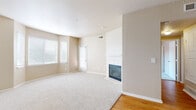 Located at 2801 Nelson Rd in Longmont, Colorado, this one-bedroom, one-bathroom residence offers a well-organized single-floor layout with a warm, neutral color palette throughout. The spacious living room is a standout feature, centered around a tile-surround fireplace with a classic white mantel, plush carpeting underfoot, and large windows with blinds that invite generous natural light. A sliding glass door provides direct access to the private balcony. The kitchen is outfitted with stainless steel appliances—including a refrigerator, range, microwave, and dishwasher—complemented by white cabinetry, granite-style countertops, and hardwood flooring. A built-in granite-topped nook off the kitchen adds a functional touch. The bedroom is generously sized, featuring vaulted ceilings, a ceiling fan, soft carpeting, and a sliding glass door to the balcony, offering an airy, open feel. Multiple closets provide ample storage. The bathroom features hardwood-style flooring, a granite-topped vanity with under-sink cabinetry, and bright overhead lighting. Additional conveniences include a dedicated laundry area and utility room. Three closets throughout the home ensure plentiful storage for everyday living.