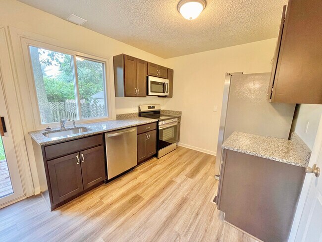 Kitchen with refrigerator, dishwasher, microwave and stove - 120 Covington Dr