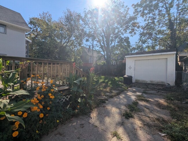 fenced in yard with garage and large wooden deck - 2401 Natchez Ave