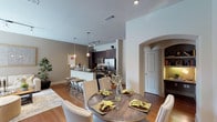 This well-appointed 1-bedroom, 1-bathroom unit is designed with an open-concept layout that seamlessly connects the living, dining, and kitchen areas. Rich hardwood flooring runs throughout the main living spaces, complemented by neutral-toned walls that create a warm, inviting ambiance. The kitchen is a standout feature, boasting dark espresso cabinetry, granite countertops, stainless steel appliances including a full-size refrigerator and built-in microwave, and a breakfast bar with pendant lighting — ideal for casual dining. The dining area accommodates a full-sized table and benefits from an elegant arched architectural detail that adds character to the space. The living room is bright and airy, with a sliding glass door that opens to a private balcony offering outdoor views. The bedroom is generously proportioned with plush carpeting, large windows that invite natural light, and direct access to a spacious walk-in closet. The bathroom features a double-sink vanity with dark cabinetry and stone countertops, complemented by tile flooring. A dedicated laundry area with full-size washer and dryer adds everyday convenience to this thoughtfully designed home.