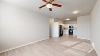 This well-designed apartment offers 1050 square feet of living space on a single floor. The layout features three bedrooms, including a spacious primary bedroom of 170 square feet, and two full bathrooms. The heart of the home is an open-concept kitchen and living area, creating a seamless flow for daily living and entertaining.

The apartment boasts modern finishes throughout, with a neutral color palette that provides a fresh, contemporary feel. Large windows in every room flood the space with natural light, enhancing the sense of openness. The kitchen is equipped with crisp white cabinetry, sleek black appliances, and a convenient layout for meal preparation.

Flooring varies throughout the space, with plush carpeting in the bedrooms for comfort and durable wood-look flooring in the main living areas and bathrooms for easy maintenance. Each bedroom is generously sized and includes a ceiling fan for improved air circulation.

The bathrooms feature clean lines with white fixtures, including tub-shower combinations. Storage is ample, with a dedicated closet space and built-in shelving. The overall design prioritizes functionality and style, creating a comfortable and inviting living environment.