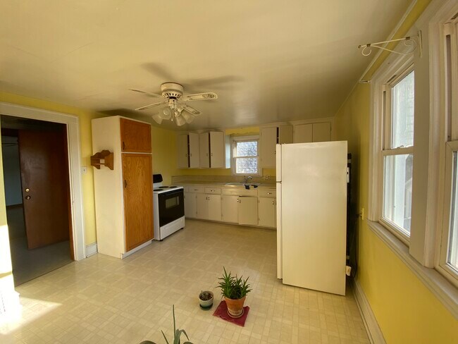 Kitchen with refrigerator & gas range - 3273 S Pennsylvania Ave