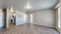 Located at 406 West Main Street in Medford, Oregon, this one-bedroom, one-bathroom unit offers a practical and well-organized single-floor layout. The interior is finished with light wood-look vinyl plank flooring throughout, complemented by neutral gray and beige wall tones and clean white trim that create a bright, cohesive aesthetic.

The open living area provides a comfortable amount of space for everyday living, with natural light entering through a window along the exterior wall. The kitchen is efficiently designed, featuring white cabinetry, a gas range, and a refrigerator, making the most of the available footprint. A pass-through or open connection between the kitchen and living area supports an open-concept feel.

The bedroom is a well-proportioned private retreat, featuring a double closet with white bifold doors for ample storage, a wall-mounted heating unit, and a window that brings in natural light with views of the surrounding neighborhood. The bathroom is equipped with a full-size tub and shower combo with chrome fixtures, providing clean, functional utility.

Throughout the unit, flush-mount ceiling lighting provides consistent illumination, and each room maintains a clean, move-in-ready condition. This unit offers a straightforward, comfortable living environment in a convenient Medford location.