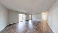 Located in Marietta, Georgia, this well-appointed one-bedroom, two-bathroom residence offers a thoughtfully designed single-floor layout. The spacious living room makes a strong first impression with rich, dark hardwood-style flooring and a sliding glass door that floods the space with natural light while providing direct access to a private balcony with outdoor views. A separate dining area features complementary wood-style flooring and a pendant light fixture, flowing seamlessly into the galley-style kitchen. The kitchen is a functional highlight, boasting white cabinetry with brushed nickel hardware, white quartz countertops, a subway tile backsplash, stainless steel appliances including a gas range, microwave, and refrigerator, and a tray ceiling with centered overhead lighting. The generously sized primary bedroom features plush carpeting, a ceiling fan with light fixture, and ample closet space. Two full bathrooms serve the residence, one of which includes a tub/shower combination with grab bars and a large vanity mirror. A dedicated in-unit laundry room accommodates a full-size washer and dryer. Throughout, neutral wall tones and clean white trim create a bright, move-in-ready ambiance.