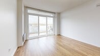 Located at 329 Boul Hymus in Pointe-Claire, Quebec, this well-designed 2-bedroom, 1-bathroom unit offers a clean, contemporary layout across a single floor. Warm hardwood flooring runs throughout, creating a cohesive and inviting atmosphere.

The open-concept kitchen and living area forms the heart of the unit. The kitchen is appointed with white shaker-style cabinetry, sleek quartz countertops, stainless steel appliances, and a central island with an integrated sink — ideal for both cooking and casual dining. The living area is bright and airy, featuring large sliding glass doors that open onto a private balcony with outdoor views.

Both bedrooms are well-proportioned, each featuring large windows that bring in generous natural light and exterior views. Baseboard heating is installed in each room. The unit also includes a dedicated walk-in closet with wire shelving systems, providing practical storage solutions.

The bathroom is finished with large-format neutral tiles in the tub-shower surround, complemented by a vanity with a light countertop and tile flooring. A hallway connects all rooms efficiently, contributing to the unit's functional flow. The overall aesthetic is modern and neutral, offering a versatile canvas throughout.