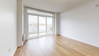 Located at 329 Boul Hymus in Pointe-Claire, Quebec, this well-designed 2-bedroom, 1-bathroom unit offers a clean, contemporary layout across a single floor. Warm hardwood flooring runs throughout, creating a cohesive and inviting atmosphere.

The open-concept kitchen and living area forms the heart of the unit. The kitchen is appointed with white shaker-style cabinetry, sleek quartz countertops, stainless steel appliances, and a central island with an integrated sink — ideal for both cooking and casual dining. The living area is bright and airy, featuring large sliding glass doors that open onto a private balcony with outdoor views.

Both bedrooms are well-proportioned, each featuring large windows that bring in generous natural light and exterior views. Baseboard heating is installed in each room. The unit also includes a dedicated walk-in closet with wire shelving systems, providing practical storage solutions.

The bathroom is finished with large-format neutral tiles in the tub-shower surround, complemented by a vanity with a light countertop and tile flooring. A hallway connects all rooms efficiently, contributing to the unit's functional flow. The overall aesthetic is modern and neutral, offering a versatile canvas throughout.