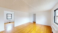 Located at 22 Hampton Court in Maywood, NJ, this one-bedroom, one-bathroom unit offers a practical and well-organized layout across a single floor. Warm-toned hardwood flooring runs throughout the main living areas, lending a classic and cohesive feel to the space. The living room is generously proportioned, featuring a textured ceiling, crisp white walls, and a paneled entry door with glass accent panels that welcome natural light. An adjoining dining area provides a defined space for meals, while the bedroom offers a comfortable footprint with a window framing neighborhood views and a radiator heating unit beneath it. The kitchen stands out with white shaker-style cabinetry, light quartz countertops, a subway tile backsplash, a stainless steel sink with a modern gooseneck faucet, and a gas range — all complemented by a window that brings in natural light. The bathroom is finished in clean white tile, featuring a shower-over-tub combination, a single vanity with mirror, and a bright window. Three closets distributed throughout the unit provide ample storage. The overall ambiance is bright, clean, and functional, making for a comfortable and move-in ready home.