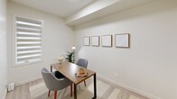Located in Edmonton's north end at Admiral Girouard Street, this well-designed one-bedroom, two-bathroom unit offers a thoughtful single-floor layout with a bright, contemporary aesthetic throughout. The open-concept living area seamlessly connects the kitchen, dining, and living spaces, all finished with light-toned luxury vinyl plank flooring and recessed lighting. The kitchen is equipped with stainless steel appliances — including a French door refrigerator, electric range, built-in microwave, and dishwasher — complemented by white flat-panel cabinetry, a subway tile backsplash, and a quartz-style countertop with a breakfast bar island for casual dining. Large windows flood the living area with natural light, creating an airy and welcoming ambiance. The dedicated dining space adjoins the living room, which opens to a private balcony overlooking the surrounding residential neighbourhood. The primary bedroom is a comfortable retreat with direct access to a walk-in closet and an ensuite bathroom featuring a glass-enclosed shower. A second full bathroom includes a soaker tub and shower combination. Additional highlights include three closets for ample storage, an in-suite laundry area, and a versatile den area suitable as a home office.