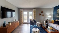 Located at 1800 Arboretum Cir in Vestavia Hills, Alabama, this thoughtfully designed single-floor residence offers a cohesive blend of modern finishes and inviting living spaces throughout. The living room is anchored by wood-look flooring, a textured ceiling, and a set of French doors that flood the space with natural light and provide outdoor access, framed by bold patterned curtains that add personality to the room. The dining area features a striking yellow accent wall, pendant lighting, and wood-look flooring, creating a vibrant yet intimate setting. The kitchen is well-equipped with stainless steel appliances, crisp white cabinetry, granite countertops, and an undermount sink — complemented by the convenience of an in-unit washer and dryer. Both bathrooms showcase white shaker-style vanities with granite countertops, dark-framed mirrors, and wood-look tile flooring, offering a clean, contemporary aesthetic. The bedrooms are generously proportioned with plush carpeting and distinct accent wall colors — soft blue in the primary suite and warm gold in the secondary bedroom — each providing a calm, restful atmosphere. Together, the rooms reflect a consistent design sensibility that balances comfort and style throughout this well-maintained Vestavia Hills residence.