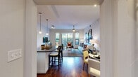 Located in Houston's desirable Montrose neighborhood, this single-floor, three-bedroom, three-bathroom residence offers a well-designed layout with thoughtful finishes throughout. The open-concept living and kitchen area serves as the heart of the home, anchored by rich hardwood flooring and abundant natural light streaming through large windows that frame lush outdoor views. A ceiling fan adds comfort to the spacious living room, which flows seamlessly into a dedicated dining area. The kitchen is appointed with dark wood cabinetry, granite countertops, a stone tile backsplash, stainless steel appliances including a gas range, and a breakfast bar with pendant lighting—ideal for casual dining and entertaining. Each of the three bedrooms is carpeted and features ceiling fans and windows with garden views. The generously sized primary bedroom includes a walk-in closet with built-in shelving. Bathrooms are well-appointed, with one featuring a large soaking tub set in tile surround. A dedicated in-unit laundry area houses a full-size washer and dryer. Two closets and three hallways round out the functional layout, making this residence a comfortable and practical home in the heart of Houston.