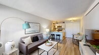 Located at 8200 Worthington Galena Rd. in Columbus, OH, this thoughtfully designed one-bedroom, one-bathroom residence offers a functional and stylish layout across a single floor. The open-concept living and kitchen area serves as the heart of the home, where wood-plank flooring, neutral gray walls, and a textured ceiling create a clean, contemporary atmosphere. Natural light streams in through a large front-facing window, brightening the living space and entry area.

The kitchen is a standout feature, showcasing granite countertops, white shaker cabinets, stainless steel appliances, and a peninsula with bar seating — ideal for casual dining or entertaining. Track lighting overhead adds a modern touch.

The full bathroom is well-appointed with a white vanity, tub-shower combination, and wood-plank flooring that ties in seamlessly with the rest of the home. The bedroom is a comfortable retreat, carpeted for warmth and featuring a window with views of the surrounding greenery. It includes direct access to both a walk-in closet and the bathroom, enhancing everyday convenience. A hallway and dedicated closet round out the layout, providing practical storage solutions throughout this efficiently designed home.