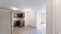 Located at 140 Spencer St in Manchester, Connecticut, this single-floor, two-bedroom, two-bathroom residence offers a thoughtfully arranged layout designed for comfortable everyday living. The kitchen is a standout feature, equipped with rich dark-espresso cabinetry, granite-style countertops, stainless steel appliances including a refrigerator, range, and dishwasher, and wood-look plank flooring that extends into the dining area. A stylish pendant light fixture adds a decorative touch to the kitchen and dining space, which opens toward the living area for a connected, functional flow. Both bedrooms feature soft wall-to-wall carpeting and windows that allow natural light to fill the rooms, creating a bright and comfortable atmosphere. Each bedroom includes dedicated closet space, and the unit provides a total of four closets throughout for ample storage. The two bathrooms are finished with wood-look tile flooring, dark vanity cabinetry, and clean white fixtures. An in-unit laundry room adds everyday convenience. The neutral color palette used throughout — warm beige walls, white trim, and complementary finishes — lends the space a clean, modern, and move-in-ready appeal.