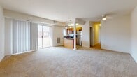 Located at 66 Lakeshore Dr in Hampton, Virginia, this single-floor residence offers a well-organized layout designed for comfortable everyday living. The open-concept living area is generously sized, featuring neutral-toned carpet and a sliding glass door that fills the space with natural light and provides outdoor access. A decorative column adds a subtle architectural detail to the transition between the living area and kitchen.

The kitchen is thoughtfully appointed with warm honey-toned cabinetry, dark granite-style countertops, stainless steel appliances including a refrigerator, range, microwave, and dishwasher, and tile flooring. A window above the sink brings in additional natural light, and a pendant light fixture adds a finishing touch to the space.

The bedrooms are carpeted and bright, with large windows and generous closet space, including double-door closets with built-in shelving and hanging rods. Each room offers a clean, neutral palette well-suited for a variety of furnishing styles.

The bathrooms feature tile flooring, warm wood-toned vanity cabinetry, white countertops, and a full tub-shower combination with clean white surround walls. Overall, the residence presents a functional and cohesive design throughout.