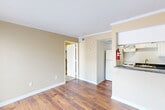 This 400 square foot apartment in Houston, TX offers a well-designed living space on a single floor. The layout includes one bedroom, measuring 180 square feet, a kitchen, and a closet. The apartment's design maximizes functionality within its compact footprint.

The kitchen is equipped with white cabinetry, providing ample storage. It features essential appliances including a refrigerator, stove, and dishwasher. The countertops are finished with a speckled granite-like material, adding a touch of elegance to the space.

The living areas showcase a mix of flooring materials. Some rooms feature warm, rich-toned hardwood floors, while others are fitted with plush carpeting, offering comfort underfoot. Large windows in the main living area and bedroom allow for abundant natural light, creating a bright and airy atmosphere.

The color palette throughout the apartment is neutral, with soft beige walls complementing the white trim and doors. This creates a versatile backdrop for various decorating styles. The apartment's design emphasizes efficiency and comfort, making it an ideal space for singles or couples seeking a cozy urban dwelling in Houston.