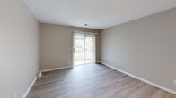 This 610 square foot single-story residence, located in Virginia Beach, VA, offers a well-designed living space that maximizes functionality. The home features a spacious 170 square foot primary bedroom, complemented by an open-concept living area that combines the kitchen and living room.

Throughout the property, light-toned wood-look flooring creates a sense of continuity and enhances the perception of space. The walls are painted in a neutral beige, contributing to a bright and airy atmosphere. Large windows and sliding glass doors in the living area allow ample natural light to flood the interior, while also providing access to the outdoor space.

The kitchen is equipped with modern stainless steel appliances, including a range and refrigerator. White cabinetry extends to the ceiling, maximizing storage, while granite countertops add a touch of elegance. A breakfast bar with a granite overhang separates the kitchen from the living area, offering additional casual dining space.

The bedroom features a large window and a spacious closet with white sliding doors, providing both natural light and ample storage. The overall design of the home emphasizes clean lines and a minimalist aesthetic, creating a contemporary living environment that feels larger than its actual square footage suggests.

Recessed lighting and ceiling-mounted fixtures throughout ensure well-lit spaces, while the neutral color palette allows for easy personalization. This efficiently designed home offers a comfortable living space in a desirable Virginia Beach location.