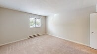 Located at 7912 Olde English Rd in Affton, Missouri, this two-bedroom, one-bathroom unit presents a straightforward and functional single-floor layout. The space is finished in a clean, neutral palette throughout, creating a bright and cohesive atmosphere.

The primary bedroom is generously sized for the overall footprint, featuring soft wall-to-wall carpeting, a window with blinds that allows natural light and outdoor views of surrounding greenery, a wall-mounted air conditioning unit, and baseboard heating. A dedicated closet with wrap-around hanging rods and shelving provides practical storage. The second bedroom also features carpet flooring, a textured ceiling, a window with blinds, and baseboard heating, offering a comfortable and well-lit space.

The kitchen is equipped with wood-style hard flooring, white cabinetry, a white electric range, and a full-size refrigerator, providing essential functionality in a compact footprint. The bathroom features a full tub-and-shower combination with white tile surround, a built-in niche, and chrome fixtures, maintaining a clean and classic look.

Overall, this unit offers a practical and livable layout suited for those seeking an efficient, move-in-ready space in the Affton community.