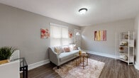 Located at 198 White Horse Pike in Collingswood, NJ, this single-floor unit offers a thoughtfully designed layout that balances comfort and functionality. The living area welcomes you with warm-toned, wood-look flooring, neutral walls, and a front entry door flanked by a window that brings in natural light. A cozy sitting area flows seamlessly into a combined dining and secondary living space, complete with a wall-mounted TV, built-in wall unit, and a compact dining table — making efficient use of the available floor area.

The kitchen is a standout feature, outfitted with dark cabinetry, white quartz countertops, a classic white subway tile backsplash, and stainless steel appliances including a gas range and over-the-range microwave. A single-basin sink with a brushed nickel faucet adds to the kitchen's clean, contemporary aesthetic.

The bedroom offers a calm retreat, featuring plush carpeting, a large window with blinds for natural light and privacy, and ample wall space. A generous closet with classic panel doors provides practical storage.

The bathroom is elegantly updated, showcasing large-format gray tile surrounding the bathtub and extending to the walls, wood-look flooring, a pedestal sink, and a window for natural ventilation. The overall ambiance of the unit is clean, modern, and move-in ready.