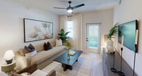 Located in Naples, FL, this well-designed 2-bedroom, 2-bathroom single-story home offers a thoughtfully planned open-concept layout with modern finishes throughout. Light wood-style flooring flows seamlessly across the living spaces, complementing the bright, neutral color palette.

The combined living, dining, and kitchen area forms the heart of the home. The kitchen is outfitted with flat-front gray cabinetry, stainless steel appliances, a subway tile backsplash, and a white-topped peninsula with bar seating, illuminated by woven pendant lights. The living area features a ceiling fan, natural light from windows and a patio door, and direct access to the private outdoor patio.

The primary bedroom is generously sized with ample closet space, while the second bedroom offers a bright window with outdoor greenery views. Both rooms share a clean, contemporary aesthetic. The primary bathroom includes a glass-enclosed walk-in shower with white tile and matte black fixtures, while the second bathroom features a full tub-shower combo with matching modern finishes and a floating vanity.

Additional highlights include a dedicated laundry area, three closets for storage, and two hallways connecting the well-organized floor plan efficiently.
