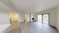 Located at 9550 W Sahara Ave in Las Vegas, NV, this well-appointed 2-bedroom, 3-bathroom residence offers a thoughtfully designed single-floor layout. The open living room serves as the heart of the home, highlighted by a white tile-surround fireplace with a mantel and sliding glass doors that lead to a private balcony, filling the space with natural light. Light-toned laminate wood flooring runs throughout the main living areas, lending a clean and contemporary feel.

The kitchen is efficiently designed with crisp white shaker cabinetry, light countertops, stainless steel appliances including a gas range, built-in microwave, dishwasher, and refrigerator, all complemented by recessed lighting. A dedicated laundry room houses a full-size Maytag washer and dryer.

Both bedrooms feature plush carpet flooring and ceiling fans. The generously sized primary bedroom includes a walk-in closet outfitted with wire shelving and organizers. The second bedroom benefits from a large window that invites natural light. Three full bathrooms, including tiled tub-shower combinations, provide ample convenience. Hallways connect all areas seamlessly, completing this functional and comfortable Las Vegas home.