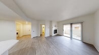 Located at 9550 W Sahara Ave in Las Vegas, NV, this well-appointed 2-bedroom, 3-bathroom residence offers a thoughtfully designed single-floor layout. The open living room serves as the heart of the home, highlighted by a white tile-surround fireplace with a mantel and sliding glass doors that lead to a private balcony, filling the space with natural light. Light-toned laminate wood flooring runs throughout the main living areas, lending a clean and contemporary feel.

The kitchen is efficiently designed with crisp white shaker cabinetry, light countertops, stainless steel appliances including a gas range, built-in microwave, dishwasher, and refrigerator, all complemented by recessed lighting. A dedicated laundry room houses a full-size Maytag washer and dryer.

Both bedrooms feature plush carpet flooring and ceiling fans. The generously sized primary bedroom includes a walk-in closet outfitted with wire shelving and organizers. The second bedroom benefits from a large window that invites natural light. Three full bathrooms, including tiled tub-shower combinations, provide ample convenience. Hallways connect all areas seamlessly, completing this functional and comfortable Las Vegas home.