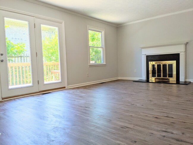 Living Room with frech doors opening onto back deck. - 3221 Hunters Point Dr