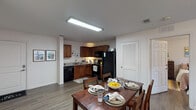Located at 2501 S 4th St in Louisville, Kentucky, this single-floor unit offers a well-designed layout that balances functionality and comfort. The kitchen is outfitted with rich warm-toned cabinetry, granite-style countertops, and a full suite of black appliances including a refrigerator, range, microwave, and dishwasher. The kitchen opens directly to a dedicated dining area, creating a natural flow for everyday living and entertaining. The living room features wood-style flooring, neutral walls, and a large window with plantation-style blinds that invite natural light into the space. The bedrooms are comfortably sized, each featuring wood-style flooring, windows with blinds, and ample room for both sleeping and study or work areas. The unit includes two full bathrooms, each finished with warm wood-toned cabinetry, neutral countertops, and wood-style flooring. One bathroom features a combination tub and shower, while the other provides a vanity with generous counter space. Throughout the unit, a consistent neutral color palette and cohesive hardwood-style flooring create a clean, unified aesthetic. The overall layout is efficient and practical, offering well-connected living spaces suited for a range of lifestyles.