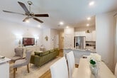 Located at 2754 Eula Rd in Biloxi, Mississippi, this two-story home features 4 bedrooms and 4 bathrooms across two thoughtfully designed floors. The main level opens into a bright, open-concept living, dining, and kitchen area with warm wood-look flooring and recessed lighting throughout. The kitchen is appointed with crisp white shaker cabinetry, granite countertops, stainless steel appliances including a side-by-side refrigerator with ice maker, an electric range, and a built-in microwave. A peninsula with a sink offers additional workspace and casual seating, flowing seamlessly into the dining and living areas. A ceiling fan anchors the living space, which also accommodates a versatile flex area suitable as a home office or secondary sitting room. The upper floor houses the spacious primary bedroom, featuring plush carpet, dual windows with natural light, a ceiling fan, and a serene neutral palette. Additional bedrooms maintain a consistent, welcoming aesthetic. Four well-appointed bathrooms serve the home, including clean white tiled bath-shower combinations. A connecting hallway with wood-look flooring and decorative accents links the staircase to the living areas, completing this efficiently planned and stylishly presented Biloxi residence.
