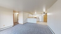 Located at 1795 Grant Street in De Pere, Wisconsin, this 2-bedroom, 2-bathroom single-floor unit offers a practical and comfortable layout. The open-concept living and kitchen area serves as the heart of the home, where soft carpet in the living room transitions to light tile flooring in the kitchen and dining space. A ceiling fan adds comfort to the area, while a sliding glass door fills the living room with natural light and provides access to a private patio.

The kitchen is well-appointed with abundant white cabinetry, a U-shaped layout, neutral countertops, tile flooring, a double-basin sink, and a full suite of appliances including a range and refrigerator. A peninsula separates the kitchen from the living space, enhancing the open feel.

Both bedrooms feature plush carpet, natural light from windows, and baseboard heating. The primary bedroom includes a mirrored sliding-door closet, providing convenient storage. The second bedroom is bright and generously proportioned.

Two full bathrooms serve the unit, each featuring tile flooring and white vanity cabinetry. One bathroom includes a lighted mirror above the vanity. Two hallways connect the rooms efficiently, and the overall layout is clean, neutral, and move-in ready.