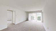 This well-appointed one-bedroom, one-bathroom residence in Frederick, Maryland offers a thoughtfully organized single-floor layout. The bright living room serves as the heart of the home, featuring plush carpeting and a large sliding glass door fitted with vertical blinds that invite abundant natural light and provide access to outdoor views. The adjacent dining room connects seamlessly to the living area, distinguished by a pendant light fixture that adds a welcoming touch.

The kitchen features warm wood-tone flooring, a dark granite-topped breakfast bar, and a window for natural light, creating a functional and practical cooking space. A refrigerator is included among the appliances.

The spacious bedroom offers generous room for furnishings, highlighted by multiple windows with vertical blinds that bathe the room in natural light. Two sets of double-door closets provide excellent storage capacity, with an additional walk-in closet also accessible from the room.

The full bathroom is finished with large-format neutral tile surrounding a classic soaking tub and shower combination, complemented by clean white fixtures. Throughout the residence, a consistent light and neutral color palette, smooth white walls, and plush carpeting in the main living areas create a clean, comfortable atmosphere ready for personalization.