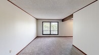 Located at 1666 Seven Pines Rd in Springfield, Illinois, this single-floor, three-bedroom, one-bathroom home offers a practical and functional layout. The interior is finished with wall-to-wall carpet throughout the living areas and bedrooms, complemented by dark wood baseboards and crown molding that add a classic touch. Textured ceilings are present throughout the home.

The spacious primary bedroom features a large sliding window with views of surrounding trees, offering a natural, serene backdrop and ample natural light. The additional bedrooms are well-proportioned, each equipped with ceiling fans with integrated lighting and windows that bring in natural light. One bedroom includes a closet with bifold louvered doors and a built-in hanging rod for convenient storage.

The kitchen is efficiently designed with warm wood cabinetry, a double-basin sink, laminate countertops, and a full-size refrigerator. It opens to an adjacent dining or pass-through counter area, supporting easy interaction between spaces.

The bathroom includes a full tub-and-shower combination with a single-piece surround. Throughout the home, dark-framed windows provide a consistent design detail, while the neutral wall tones keep the overall ambiance light and versatile. The layout makes efficient use of its footprint, providing comfortable living across all rooms.