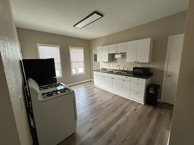 Oven, fridge, microwave, and other kitchen items included - 1449 W 50th St