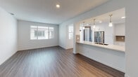 Located at 4868 Cypress St in Montclair, California, this single-floor residence offers a clean, contemporary design with a thoughtfully planned open layout. The living and dining area is finished with warm wood-look luxury vinyl plank flooring and is bathed in natural light through large windows fitted with horizontal blinds. It flows seamlessly into the kitchen, which is separated by a peninsula counter with a stainless steel sink and elegant pendant lighting overhead. The kitchen itself is well-equipped with bright white shaker-style cabinetry, stone countertops, a grey subway tile backsplash, and stainless steel appliances including a gas range, built-in microwave, and refrigerator. A dedicated in-unit laundry nook accommodates a full-size washer and dryer, adding everyday convenience. The bedrooms feature plush carpeting, neutral wall tones, and windows that bring in natural light. One bedroom includes access to a spacious walk-in closet with built-in shelving and additional cabinetry. Two full bathrooms are finished with wood-look flooring, white vanity cabinets, stone countertops, large mirrors, and shower-tub combinations, maintaining a consistent, modern aesthetic throughout the entire home.