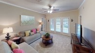 This single-floor, two-bedroom, two-bathroom residence at Kendall offers a well-organized layout with comfortable living spaces and consistent finishes throughout. The kitchen is equipped with warm wood cabinetry, granite countertops, black appliances including a range, microwave, and refrigerator with ice dispenser, and tile flooring. A peninsula provides additional counter space and separates the kitchen from the adjoining living and dining areas.

The living room features plush carpeting, crown molding, a ceiling fan, and French doors that allow natural light and outdoor views to fill the space. It connects openly to a dedicated dining area, which includes crown molding and wall sconce accents, creating a cohesive entertaining flow.

Both bedrooms are carpeted and equipped with ceiling fans. The primary bedroom includes an en-suite bathroom featuring a double-sink vanity with granite countertops, tile flooring, and a separate shower. The second bedroom benefits from natural light through multiple windows. The second bathroom mirrors the same granite vanity aesthetic and includes a tub-shower combination with tile flooring, maintaining a consistent design standard throughout the home.