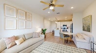 Located at 295 Royal Tern Cir in Rockledge, Florida, this well-designed one-bedroom, one-bathroom residence offers a thoughtfully arranged single-level floor plan that maximizes every square foot. The open-concept living area flows seamlessly from the living room into the dining space and kitchen, creating a cohesive and functional layout. Light wood-style flooring runs throughout the main living areas, complemented by neutral-toned walls and recessed lighting that enhance the airy, bright atmosphere. Ceiling fans in both the living room and bedroom add comfort and a casual Florida feel.

The kitchen is a standout feature, boasting white shaker cabinetry, light quartz countertops, a subway tile backsplash, and a full suite of stainless steel appliances including a refrigerator, range, microwave, and dishwasher. A central island with bar seating and elegant pendant lighting above serves as both a prep space and casual dining hub. Large windows in the living room allow generous natural light to pour in, with a glass-panel door providing additional brightness and outdoor access.

The bedroom is a serene retreat, featuring plush carpeting, multiple windows with natural light, and a ceiling fan. The bathroom is clean and classic, offering white vanity cabinetry, quartz countertops, and a full tub-shower combination with tile surround.