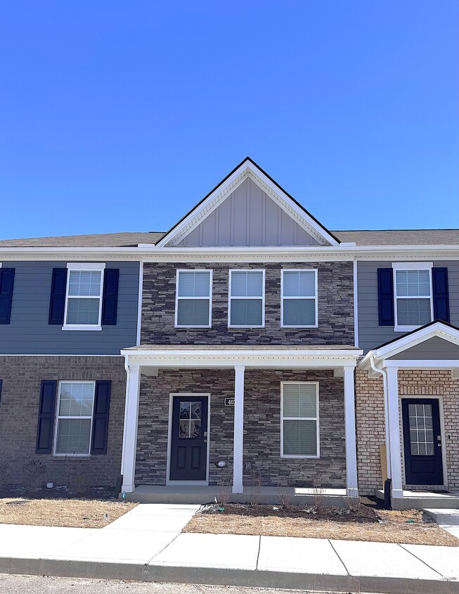 This stone front two-story townhome is brand new. It is within one block of the community pool. - 403 Augustine Dr