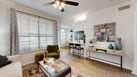 Located at 200 Kellington Dr N in Houston, TX, this thoughtfully designed 2-bedroom, 1-bathroom residence offers a cohesive open-concept layout across a single floor. Light wood-style flooring flows throughout, complemented by crisp white walls and crown molding that lend a clean, polished aesthetic.

The living room is bright and inviting, featuring a ceiling fan, large windows with natural light, and charming built-in shelving niches that add both character and storage. It connects seamlessly to the dining area, which is anchored by an elegant arched window and an eye-catching pendant light overhead.

The kitchen is well-equipped with white shaker cabinetry, white quartz countertops, subway tile backsplash, and a full suite of stainless steel appliances, including a refrigerator, range, microwave, and dishwasher. A breakfast bar provides additional seating and connects the kitchen to the living and dining areas.

The primary bedroom is generously sized, offering natural light through large windows, a ceiling fan, and direct access to the full bathroom. The bathroom features white cabinetry with matte black hardware, a wide vanity, and a tub-shower combination. Adjacent to the bathroom is a spacious walk-in closet with wire shelving and ample hanging space. A hallway connects all areas of the home, completing this efficient and comfortable floor plan.