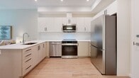 Located at Linley Valley Drive in Nanaimo, BC, this efficiently designed one-bedroom, one-bathroom unit offers a clean, contemporary aesthetic with thoughtful use of space throughout. Light hardwood flooring runs through the main living areas, complementing the bright, neutral color palette that creates an open and airy atmosphere.

The kitchen is a standout feature, outfitted with a full suite of stainless steel appliances including a bottom-freezer refrigerator, electric range, built-in microwave, and dishwasher. Crisp white upper cabinetry is paired with warm-toned lower cabinets and light quartz countertops, offering ample storage and a modern two-tone design. Recessed lighting adds a polished finish overhead.

The bedroom is a comfortable and serene retreat, featuring warm hardwood flooring, soft neutral walls, and a mirrored sliding closet that enhances the sense of space. A full-length arched mirror and tasteful wall art contribute to the room's understated elegance.

The bathroom is finished with marble-style tile flooring, a full soaker tub with shower, a white quartz vanity countertop, and modern cabinetry — offering a clean, functional space with refined details.

Overall, this unit presents a cohesive, modern living environment well-suited for those seeking practical comfort in a contemporary setting.