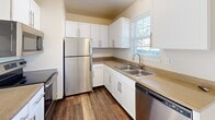 Located at 2917 Highland Dr in Hudsonville, Michigan, this three-bedroom, two-bathroom home spans three floors, offering a well-organized layout with dedicated spaces for living, sleeping, and storage. The main level features an open-concept living, dining, and kitchen area. The kitchen is equipped with stainless steel appliances—including a refrigerator, range, over-the-range microwave, and dishwasher—complemented by white cabinetry, neutral countertops, a double-basin sink, and durable hardwood-style flooring. The living area flows naturally from the kitchen and opens via sliding glass doors to an outdoor deck, allowing natural light to fill the space. Each of the three bedrooms is finished with plush carpet flooring and features a closet, with windows providing natural light and neighborhood views. The generously sized primary bedroom offers ample room for comfortable furnishing. Both bathrooms are finished with hardwood-style flooring, white vanity cabinetry, and tub-shower combinations. The lower level includes a basement with a utility panel, carpeted floors, and additional storage potential. Throughout the home, six closets provide substantial storage, and three staircases connect each floor efficiently. The overall aesthetic is clean, bright, and move-in ready.