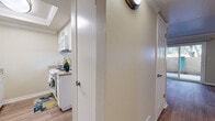 This single-floor residence in Fremont, California offers a thoughtfully designed layout that balances functionality and comfort throughout its living spaces. Crown molding accents the ceilings consistently across the unit, lending a polished, cohesive aesthetic to each room.

The open living area features warm wood-look flooring and a ceiling fan, creating an airy, welcoming atmosphere. A pass-through counter connects the living space to the kitchen, enhancing the open-concept feel. Sliding glass doors lead directly to an outdoor patio area, allowing natural light to fill the room and providing easy outdoor access.

The kitchen is efficiently arranged with white cabinetry, light countertops, and white appliances including a range, microwave, and dishwasher. Wood-look flooring continues here, complementing the clean, bright design.

The bedroom features plush carpeting, a generously sized sliding closet with built-in shelving, and a large window that invites natural light. An additional carpeted room also offers outdoor access via a glass door, providing flexibility in use.

The bathroom includes a full tub-shower combination with a window above for ventilation and natural light. Throughout, neutral tones and clean finishes create a calm, livable environment well-suited to the Fremont area.