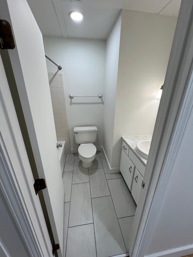 Bathroom with new tile floor & vanity - 212 Riverside Dr