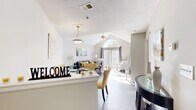 This 650 square foot apartment in Tucker, GA offers a thoughtfully designed living space with modern amenities. The single-story layout includes one bedroom, one bathroom, and an open-concept living area. The living room boasts vaulted ceilings with a striking arched window, flooding the space with natural light. A sliding glass door leads to an outdoor area, enhancing the sense of spaciousness.

The kitchen features updated appliances, white cabinetry, and granite countertops, complemented by a stylish tile backsplash. The bedroom, measuring 140 square feet, provides ample space and is adorned with neutral tones and plush carpeting. The bathroom showcases a tub/shower combination with decorative curtains.

Throughout the apartment, you'll find a cohesive design aesthetic with a neutral color palette, accented by pops of yellow in the furnishings. The living area includes a cozy fireplace with built-in shelving, adding both warmth and functionality. Laminate flooring in wood tones runs through the main living spaces, contributing to the modern feel of the home.

Additional amenities include in-unit laundry facilities and a dedicated dining area, making this compact apartment both stylish and practical for comfortable living.