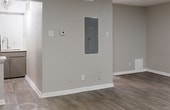This 400 square foot apartment maximizes its limited space with a thoughtful, open-concept design. The single-floor layout seamlessly integrates a living room, kitchen, and storage areas. The living area is spacious and bright, with a large window allowing natural light to flood the space. Neutral-toned walls and modern light wood-look flooring create a cohesive, contemporary aesthetic throughout.

The kitchen, while compact, is efficiently designed with sleek appliances, including a full-sized refrigerator and range. Light-colored cabinetry and a stainless steel sink contribute to the modern feel. A breakfast bar separates the kitchen from the living area, providing additional counter space and a casual dining option.

Storage is well-considered, with a dedicated closet featuring built-in shelving and hanging space. The apartment also includes practical elements such as recessed lighting and a centrally located electrical panel for easy access.

Despite its small footprint, the apartment feels open and airy, thanks to its minimalist design and clever use of space. It's an ideal dwelling for those seeking a low-maintenance lifestyle or a cozy urban retreat.
