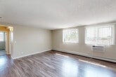 Located at 5021 Valley Lane in Streamwood, IL, this 2-bedroom, 1-bathroom residence offers a well-organized single-floor layout designed for comfortable everyday living. The living room is a bright, open space featuring wood-style plank flooring, neutral-toned walls, a textured ceiling, and dual windows dressed with vertical blinds that allow generous natural light to fill the room. Baseboard heating and a wall-mounted AC unit provide year-round climate control.

The kitchen is a functional highlight of the home, outfitted with gray shaker-style cabinetry, granite-look countertops, and a full suite of stainless steel appliances including a gas range, dishwasher, and refrigerator. The wood-style flooring continues seamlessly from the living area into the kitchen, reinforcing a cohesive aesthetic.

Both bedrooms are carpeted and feature neutral walls and textured ceilings. The primary bedroom includes a double closet and a hallway connection to the bathroom. The second bedroom offers a window with exterior views of the surrounding neighborhood.

The bathroom is cleanly appointed with a granite-top vanity, blue-gray cabinetry, a full tub-shower combination, and wood-style flooring. A hallway connects all rooms, providing an efficient and logical flow throughout the space.