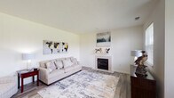 This single-floor residence offers a thoughtfully designed layout with a comfortable mix of living spaces. The living room serves as a welcoming centerpiece, featuring wood-look flooring, a tile-surround fireplace, and neutral walls that create a bright, airy atmosphere. Adjacent to the living area, a dedicated dining space benefits from a large window that frames scenic outdoor greenery, filling the room with natural light.

The kitchen is equipped with warm honey-toned wood cabinetry, granite-look countertops, a gas range, and a full suite of appliances including a refrigerator and over-the-range microwave, providing ample storage and prep space.

The bedroom is carpeted and well-lit, featuring a ceiling fan and a window that allows in natural light. A versatile bonus room, also carpeted and ceiling fan-equipped, offers flexible use as a home office, gym, or additional sleeping area.

The full bathroom includes a vanity with under-sink storage, a large mirror, and a tub-shower combination. Wood-look flooring extends through the bathroom, complementing the home's cohesive design. A dedicated in-unit laundry closet houses a full-size washer and dryer, adding everyday convenience. Throughout the home, neutral tones and consistent finishes create a clean, functional living environment.